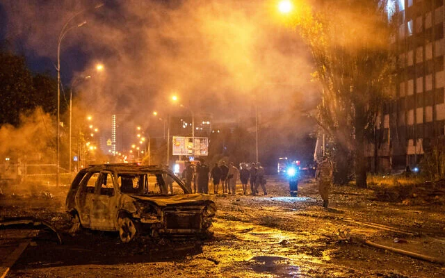 Firefighters respond after a Russian ballistic missile strike damaged warehouses and buildings in Kyiv, Ukraine.