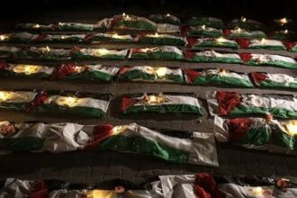 Gaza holds a mass funeral for around 100 Palestinians, including 70 children, as rescuers continue searching for bodies under destroyed buildings.