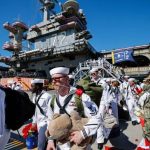 The USS Abraham Lincoln returns to California after 322 days deployed, including 265 consecutive days at sea, amid reports of shortages and crew hardship