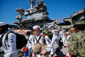 The USS Abraham Lincoln returns to California after 322 days deployed, including 265 consecutive days at sea, amid reports of shortages and crew hardship